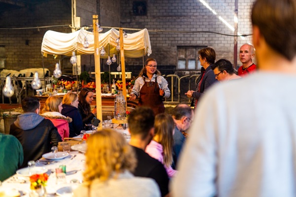 Group listens to the chef's explanations during a barbecue workshop at Buiten Eten in Someren